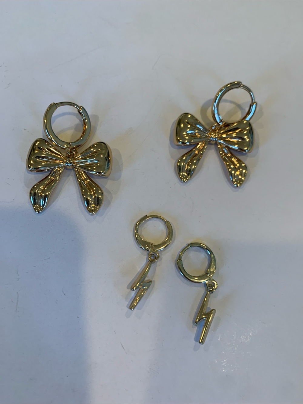 ⁠2 Pair Gold Tone Huggie Hoop Earrings Bundle Bow Ribbon & Lightning Bolt Dangle